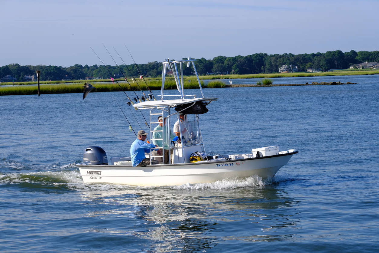 Virginia Beach, Virginia; USA 08/24/2024: Along the inlet to the Chesapeake Bay fishing boats with their fishing rods make their way out to the Chesapeake Bay for a days fishing trip.