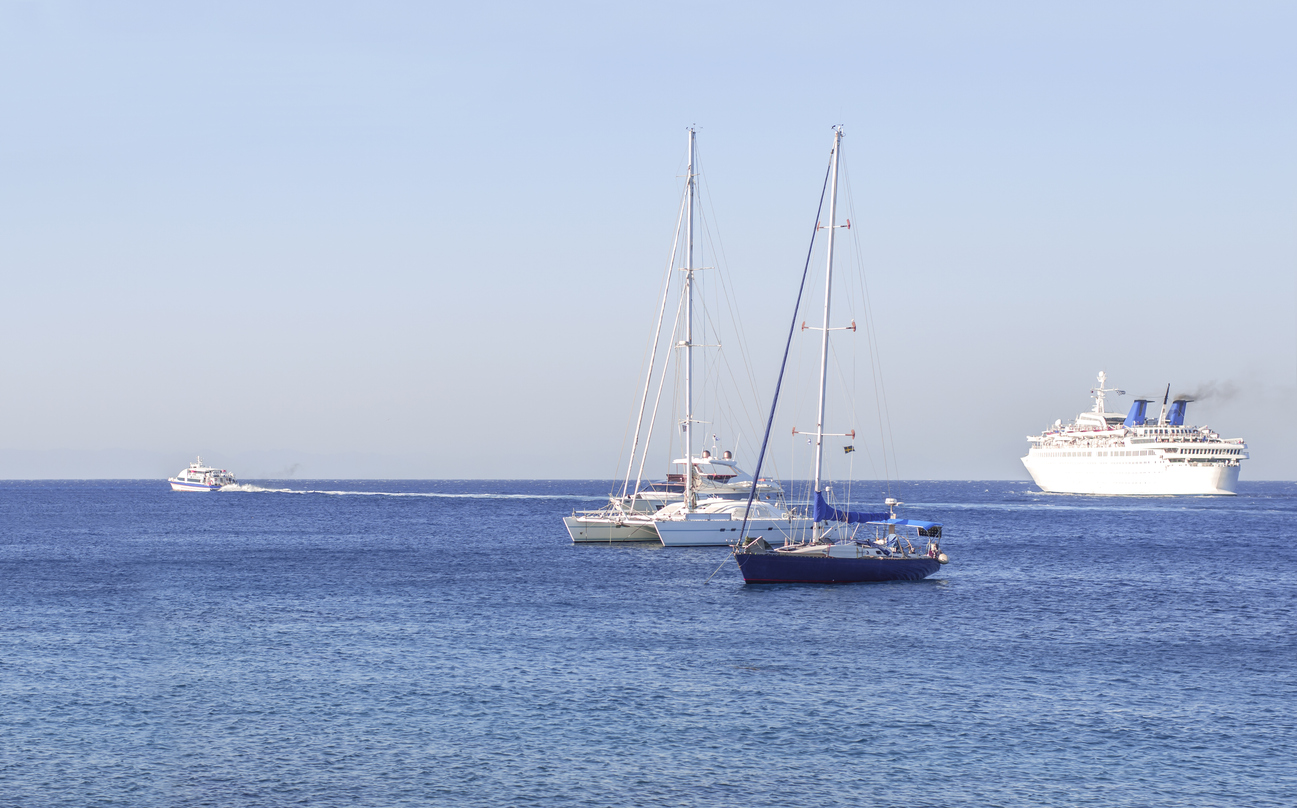 Several boats sailing on the clear blue sea 