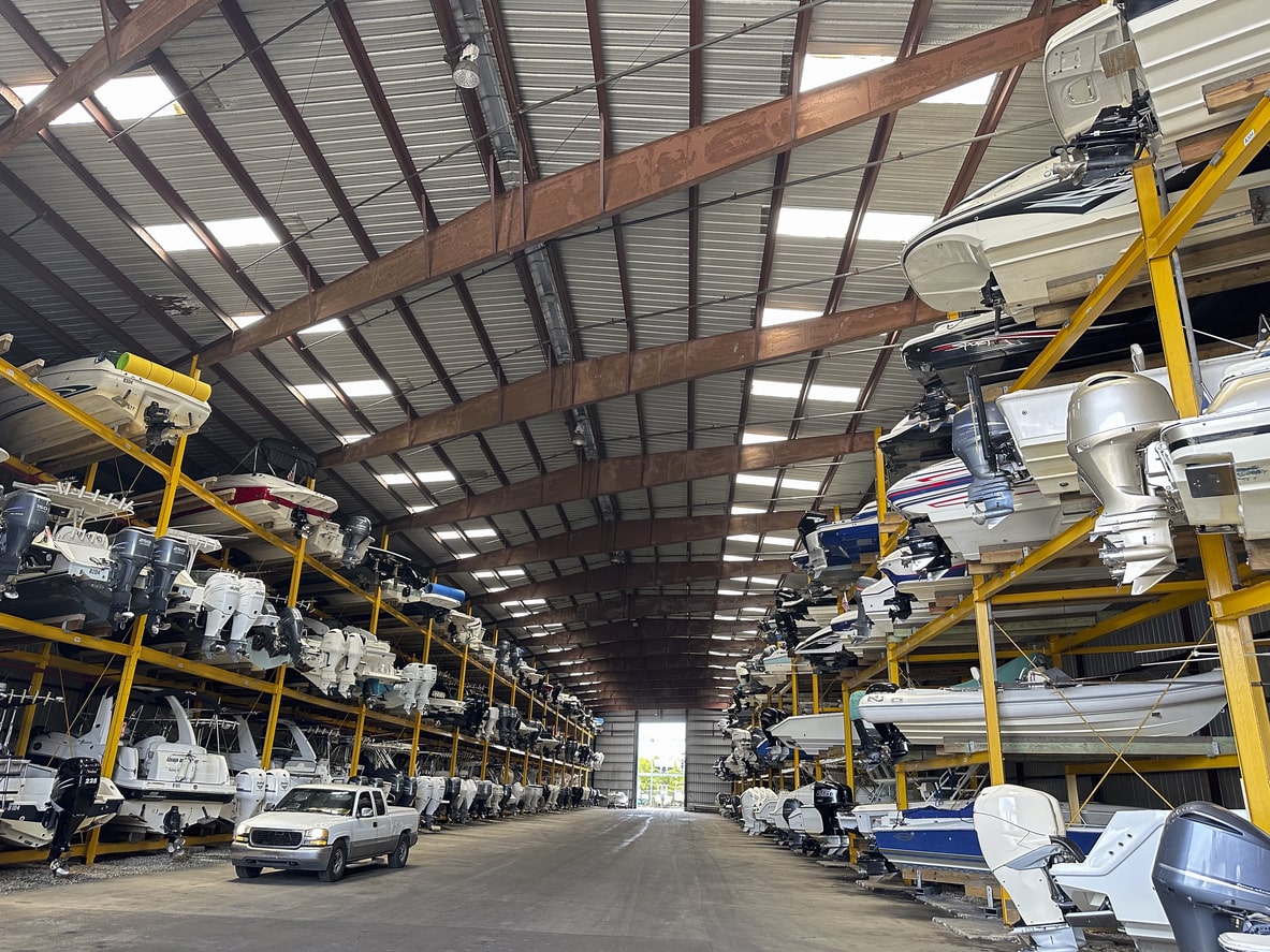 Different boats are stored in an indoor boat storage.