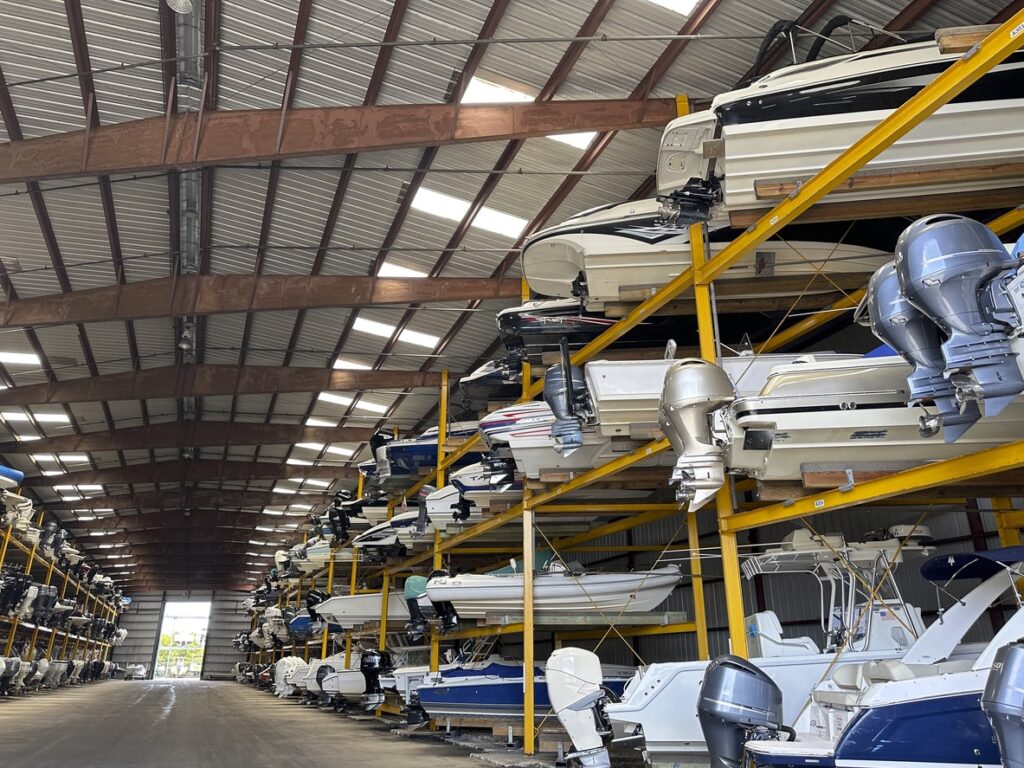 A pile of boats stored in an indoor boat storage.