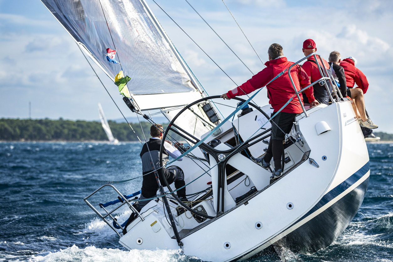 Sailing crew on sailboat in action on regatta. Models and event regatta property released.