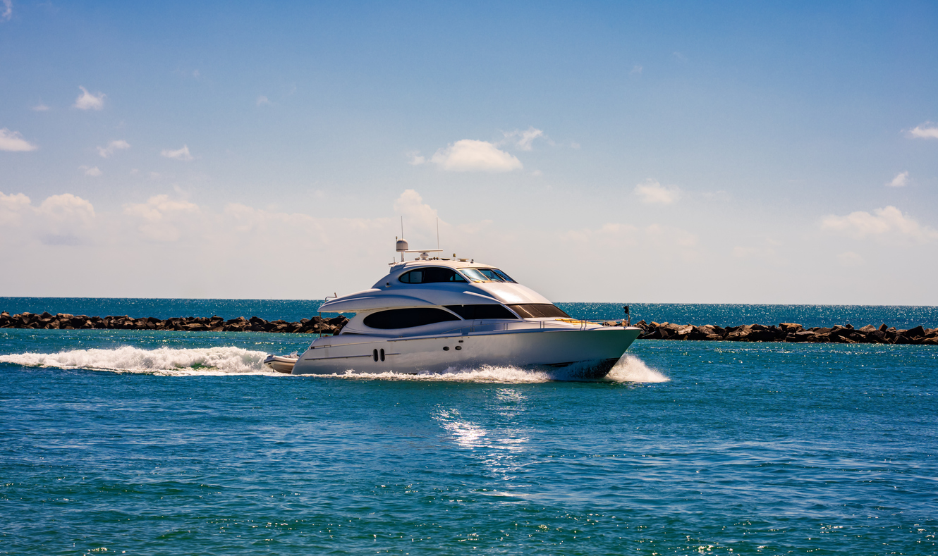 Yacht sailing on turquoise waters. Luxury superyacht at sea. Miami Beach with yachts. Tropical seascape with a sailboat. Cruise ship near the coastline. Sunset yacht voyage in Florida. Yacht in ocean