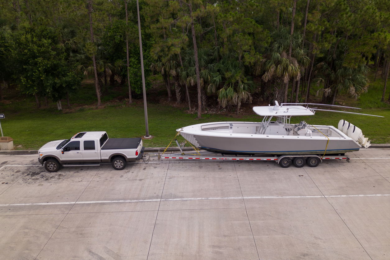 pickup truck with boat on parking lot