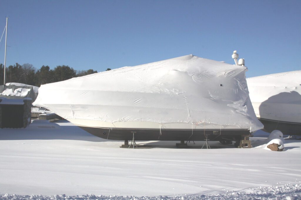 Plastic shrink wrap on boat, to protect boat and interior of boat from the winter elements.